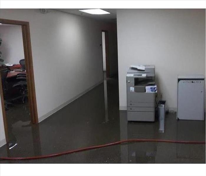 water soaking carpet in office, printer on back wall