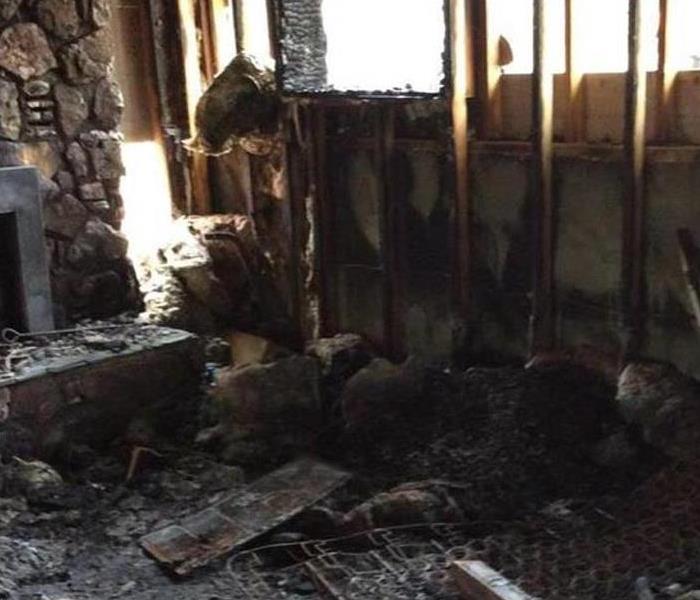 burned interior, fireplace seen, mattress spring on floor